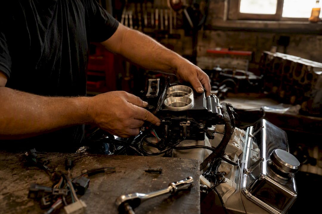 Hands installing Sniper EFI throttle body