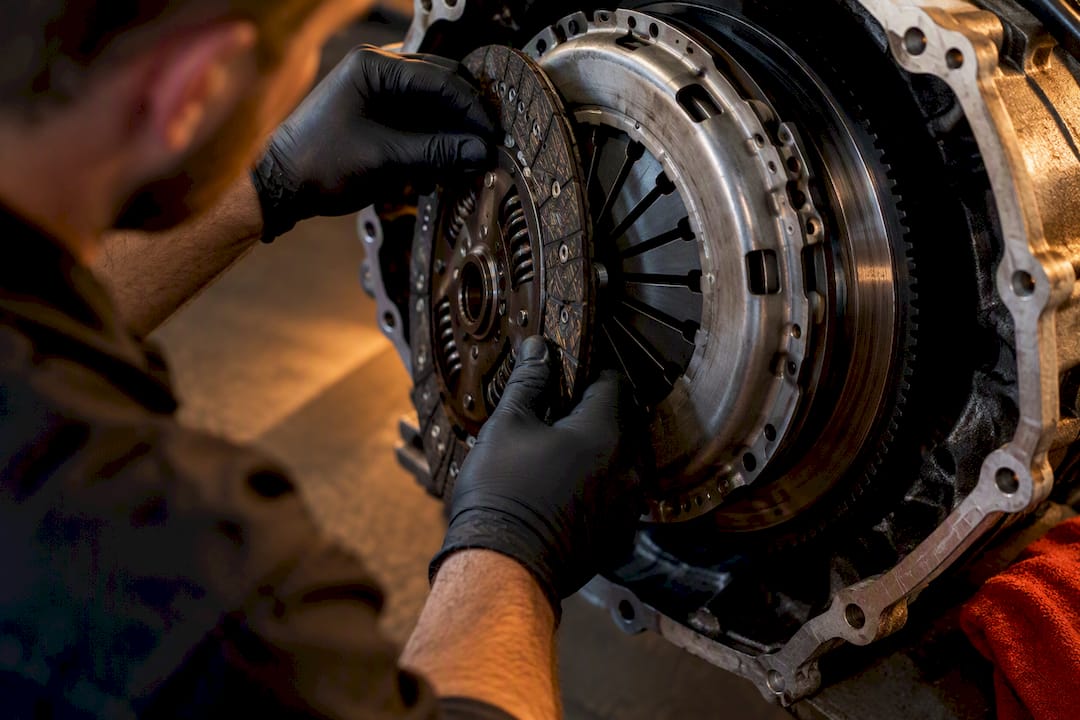 Technician inspecting clutch and flywheel fitment